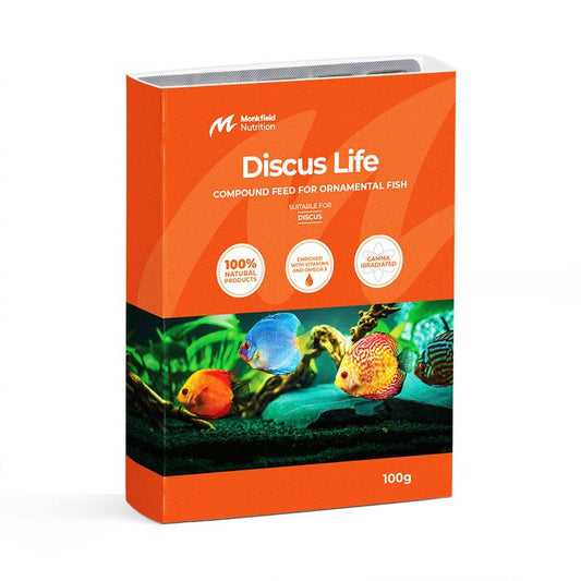 Packaging of Monkfield Nutrition Discus Life compound feed for ornamental fish, featuring an orange box with an image of colorful discus fish swimming in an aquatic environment, suitable for discus fish, enriched with vitamins and omega-3, and gamma irradiated for safety.