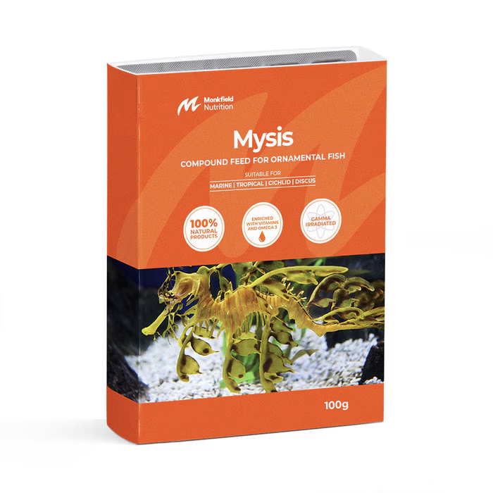 Packaging of Monkfield Nutrition Mysis compound feed for ornamental fish, featuring an orange box with an image of a leafy sea dragon swimming near aquatic plants, suitable for marine, tropical, cichlid, and discus fish, enriched with vitamins and omega-3, and gamma irradiated for safety.