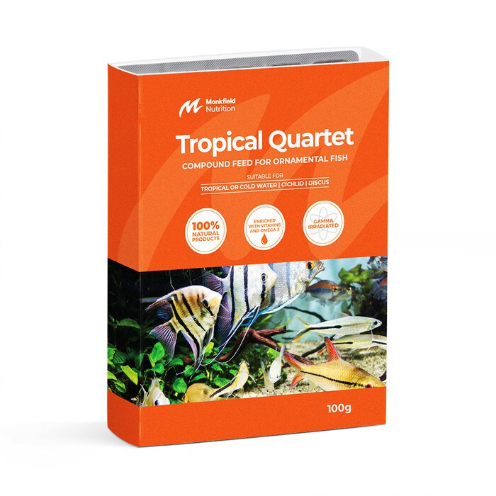 Packaging of Monkfield Nutrition Tropical Quartet compound feed for ornamental fish, featuring an orange box with an image of various tropical fish swimming in a planted aquarium, suitable for tropical or cold water, cichlid, and discus fish, enriched with vitamins and omega-3, and gamma irradiated for safety.