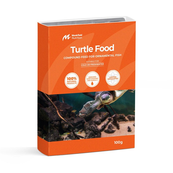 Packaging of Monkfield Nutrition Turtle Food compound feed for ornamental fish and turtles, featuring an orange box with an image of a turtle swimming near rocks, suitable for cold or freshwater environments, enriched with vitamins and omega-3, and gamma irradiated for safety.